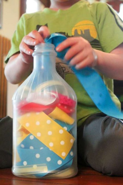 Fine motor play with ribbon -- great busy idea for toddlers to do