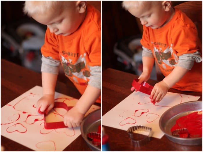 Super simple Valentine’s Day art activity idea for toddlers to try painting with heart shaped cookie cutters for a lovely collage to display at home.