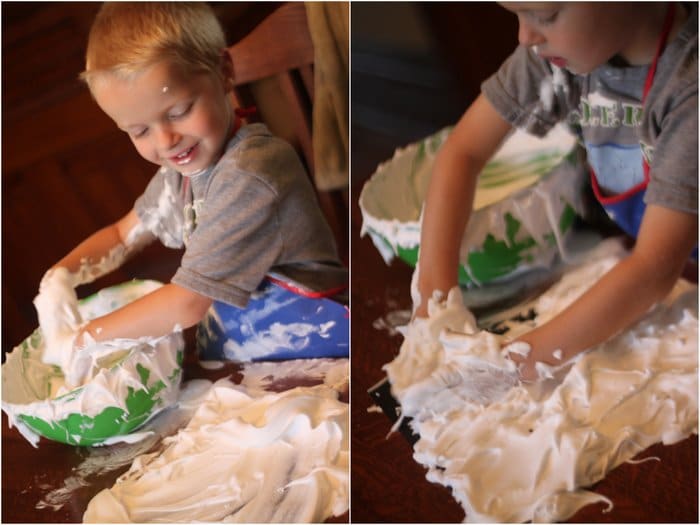 Mixing shaving cream and glue together and spread it all over the black paper.