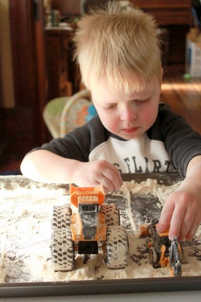Add trucks and diggers to your flour sensory play activity