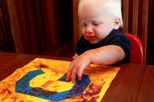 Homemade edible finger paint to make tape resist art with toddlers