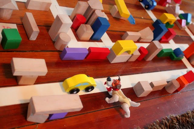 preschooler building a city with blocks