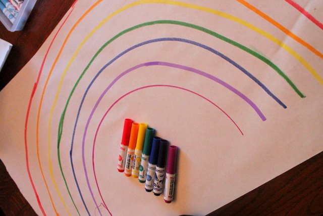 Draw a rainbow to go on a color scavenger hunt for toys to make a rainbow