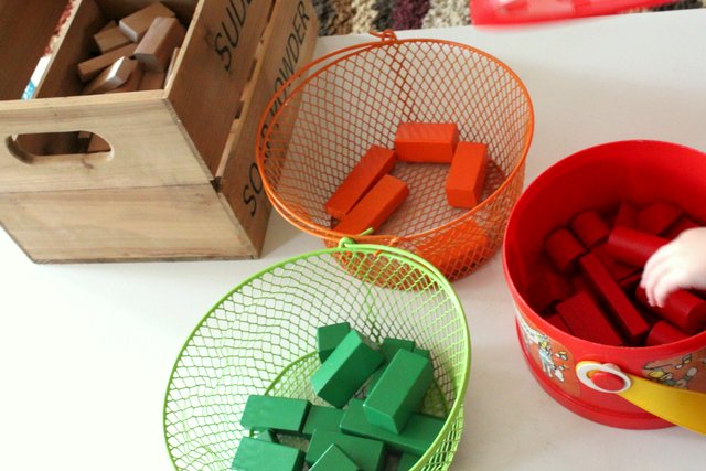 Sorting blocks into colored baskets 