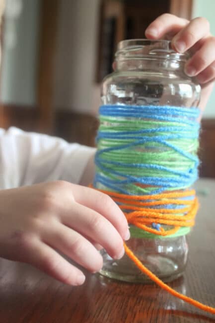 wrapping the yarn around the vase