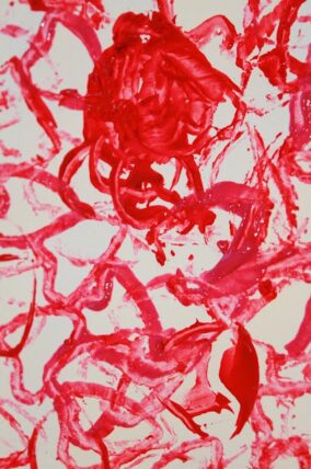 Red and white heart shapes stamped across a large sheet of paper