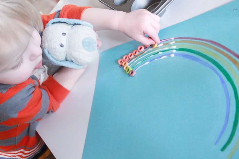 Work on color matching with a cute rainbow cereal craft for kids!