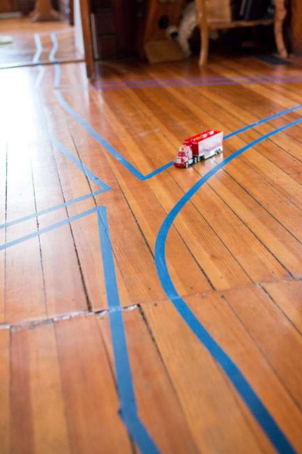 Make a tape road through rooms, make intersections, go around rugs and under tables.