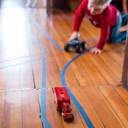 Make a tape road through rooms, make intersections, go around rugs and under tables.
