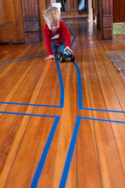Get the kids moving with this easy gross motor activity you can do at home! Create a tape road for this fun and super simple toddler and preschooler activity!