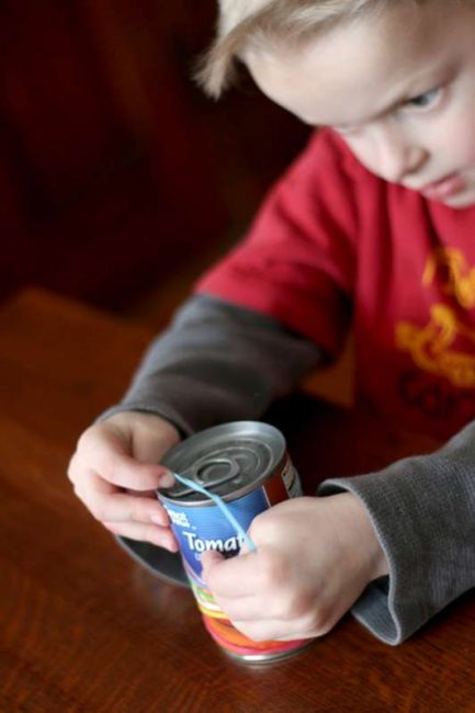 This activity is a great way to keep kids busy - just rubber bands and a soup can from the pantry!