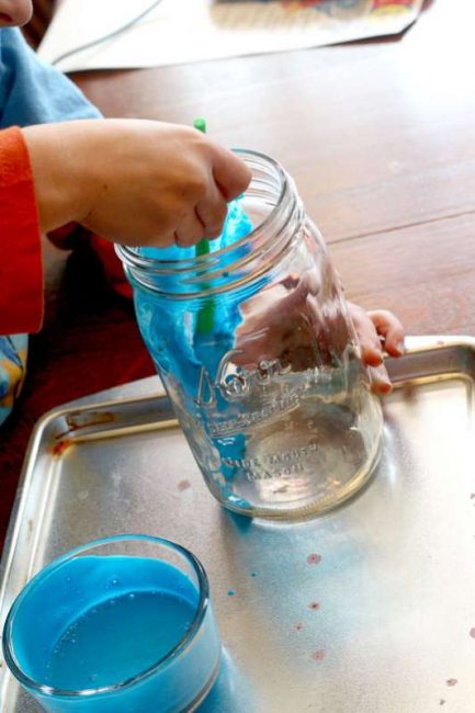 Paint the mason jars with colored glue. It's such a creative painting activity for kids!