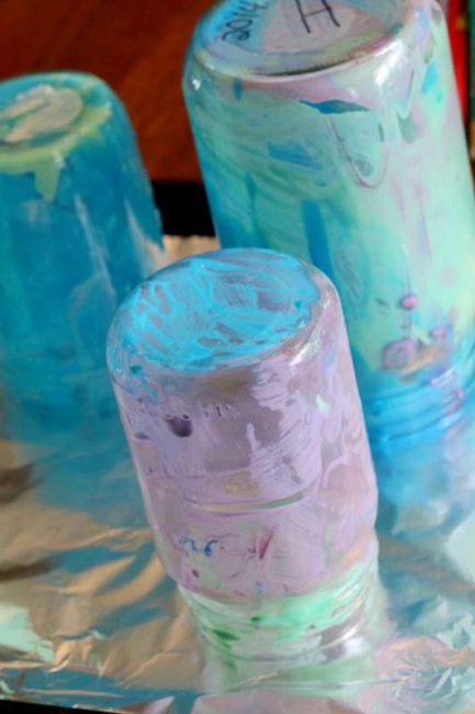 Let excess paint drip off glass Mason jars