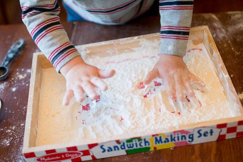 Making handprints is a fun way to play in your flour sensory tray!