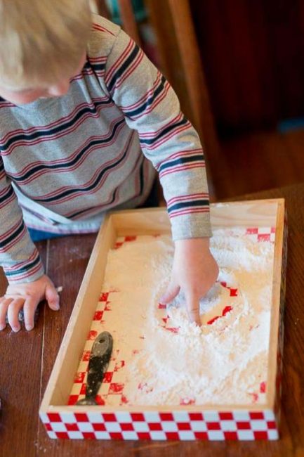 Making marks in flour for prewriting -- simple idea for toddlers!