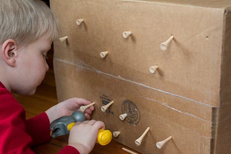 Hammer golf tees into a cardboard box for a fine motor activity that toddlers and preschoolers will love to play with! Fun twist on a classic.