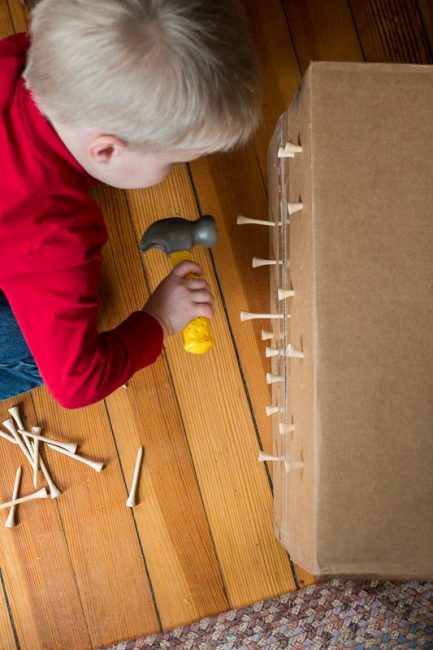Upcycle a cardboard box with this simple fine motor hammering activity using golf tees. Perfect low prep activity for toddlers and preschoolers to do at home.
