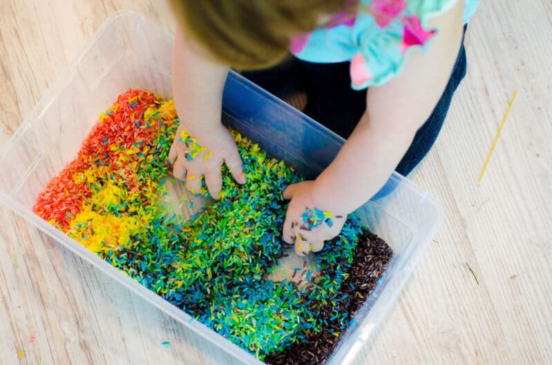 A rainbow rice sensory bin is great for toddlers!