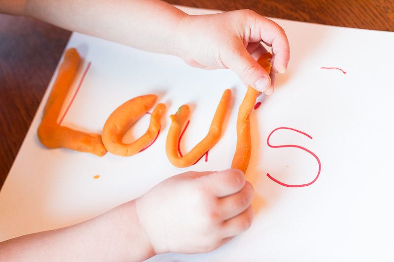 A play dough activity that gets kids strengthening their hands and learning their name.