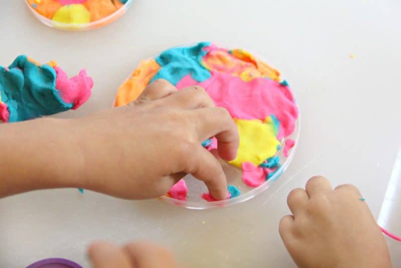 Use play dough and a recycled plastic lid to make a stunning play dough suncatcher craft with the kids!