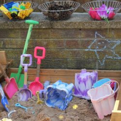 Add loose parts and small toys to your sandbox for creative play!
