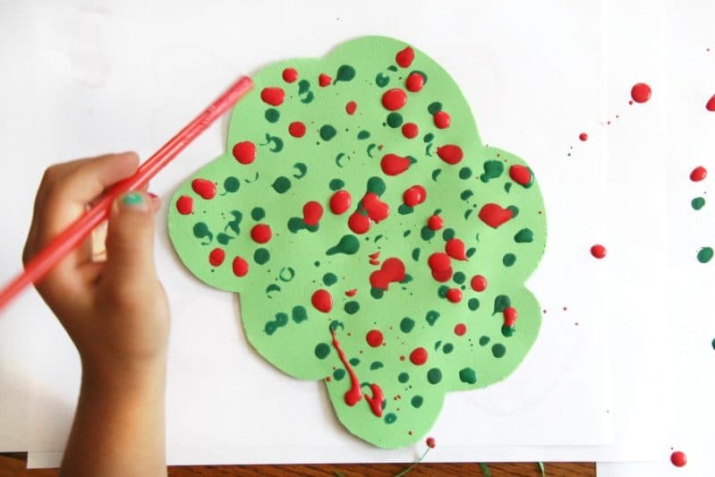 Create a straw drop painting apple tree craft to work on fine motor skills.