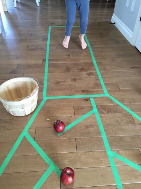 Work on gross motor skills when you go apple picking indoors!