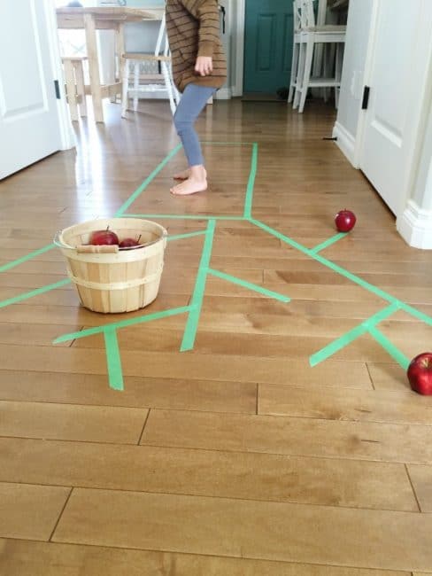 Work on gross motor skills when you go apple picking indoors!
