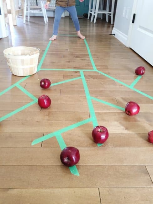Work on gross motor skills when you go apple picking indoors!
