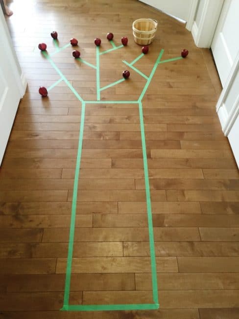 Make a painters' tape apple tree for a fun gross motor activity with lots of movement!