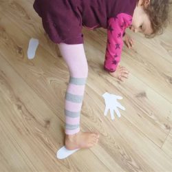 Indoor activity for preschoolers who love to move about. Get your kids active with this paper hands and feet gross motor activity! Great for body awareness, stretching and strengthening muscles.