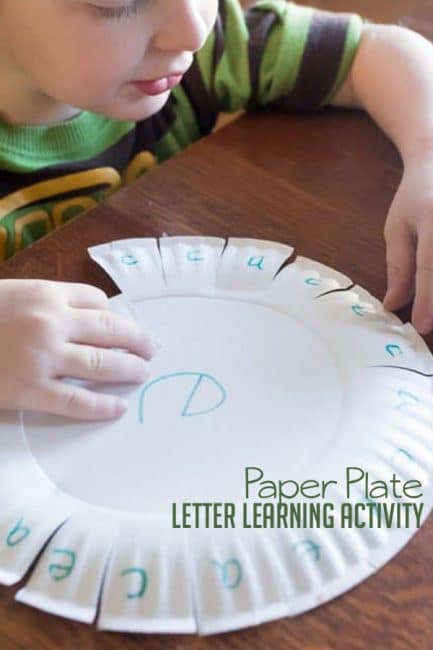 Using a paper plate to practice learning a couple of letters -- so smart!