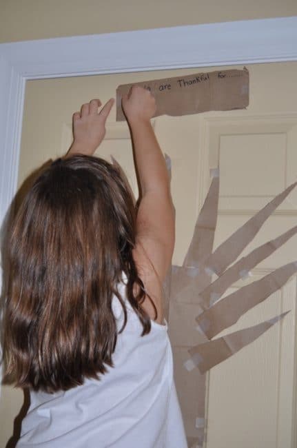 Use on-hand items to make a large gratitude tree activity art piece and talk about what you're thankful for with your kids.