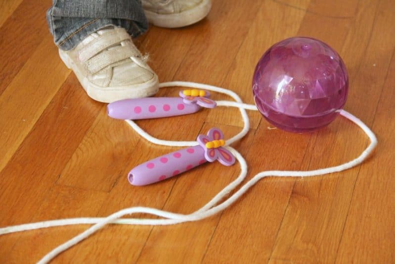 Use a ball and a jump rope to play an follow the line motor planning activity with kids.