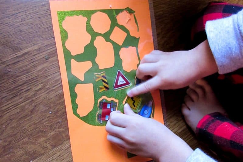 Make a quick sticker puzzle to help your child with fine motor skills.