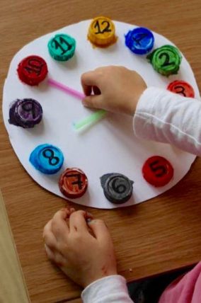 Upcycle old bottle caps to make this color matching clock for preschoolers.
