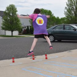 Balance beam walking and star jumps are part of a really fun Superhero Playground Challenge!
