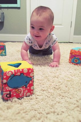 Get your baby moving with this simple gross motor baby play idea! Practice crawling and learning with your baby.