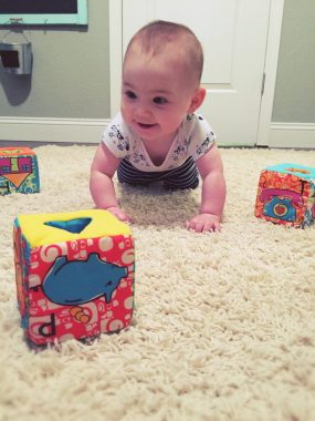 Get your baby moving with this simple gross motor baby play idea! Practice crawling and learning with your baby.