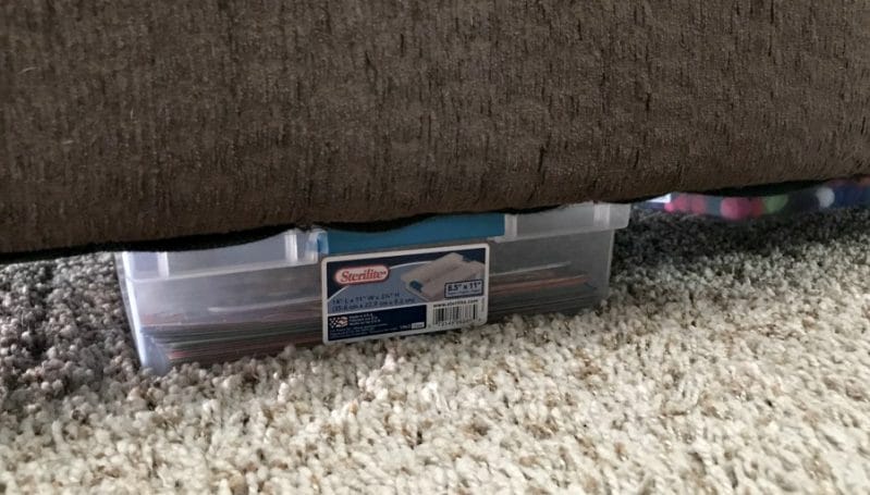 Store your DIY busy boxes out of the way, like under a couch.