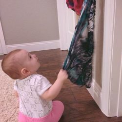 Try this simple baby scarf pull activity to get your baby moving! Encourage gross motor skills with this low-prep baby play idea.