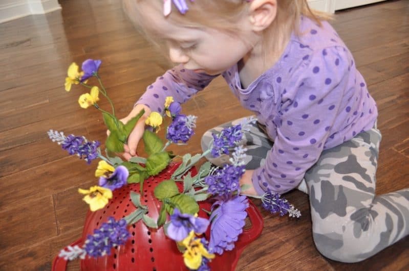 Practice fine motor skills when you add a colander to your spring flower pretend play.