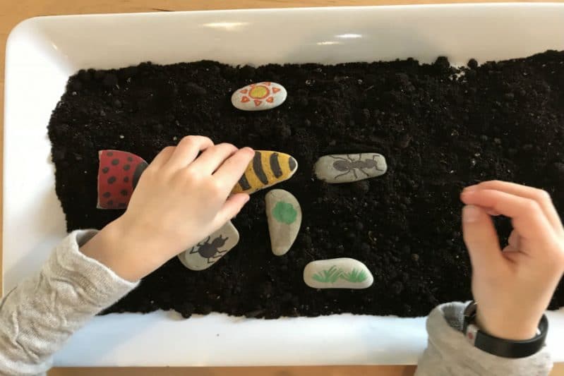 Add sensory play to your DIY story stones with a tray of dirt!