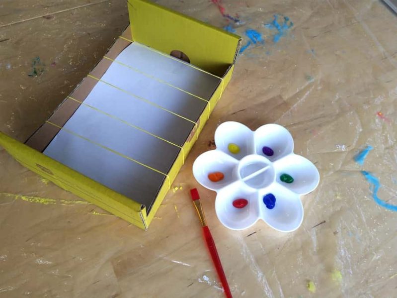 Grab supplies from around the house: rubber bands, a box, paint and paper!