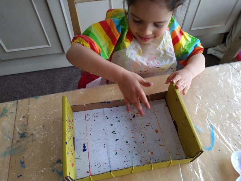 Rubber band splatter painting is the best for 4 year olds!