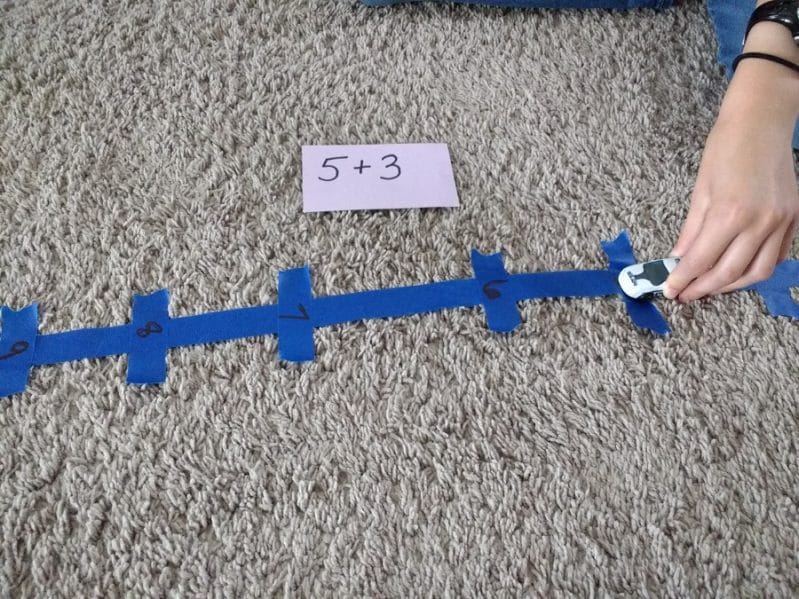 Set up a simple number line car race to help build math fact fluency with your child!