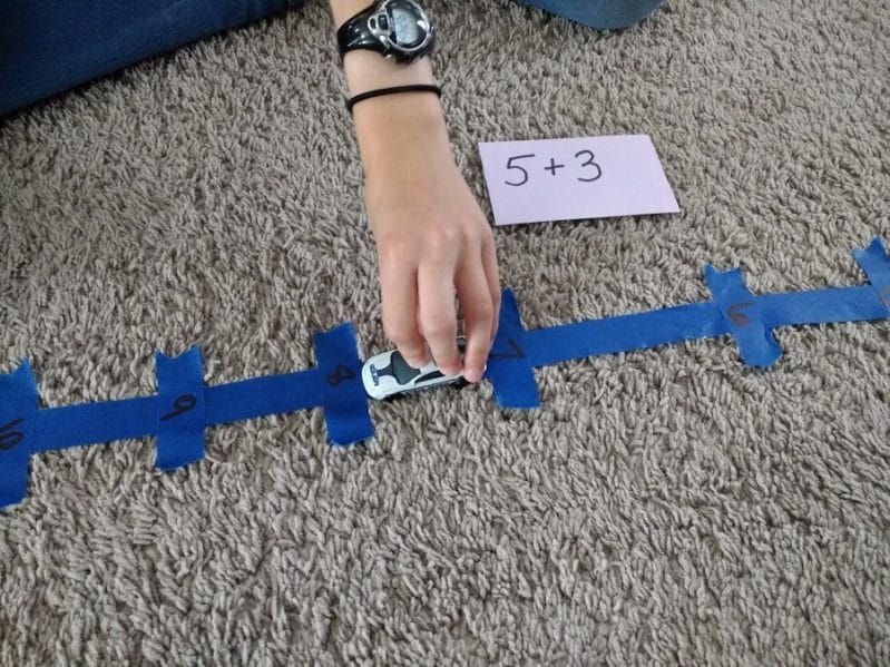 Set up a simple number line car race to help build math fact fluency with your child!