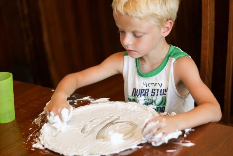 Help your child fall in love with writing when you add in fun sensory materials, like shaving cream!