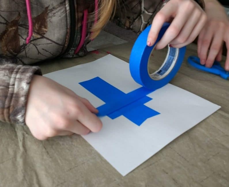 Make a tape resist cross using and Easter eggs painting technique!
