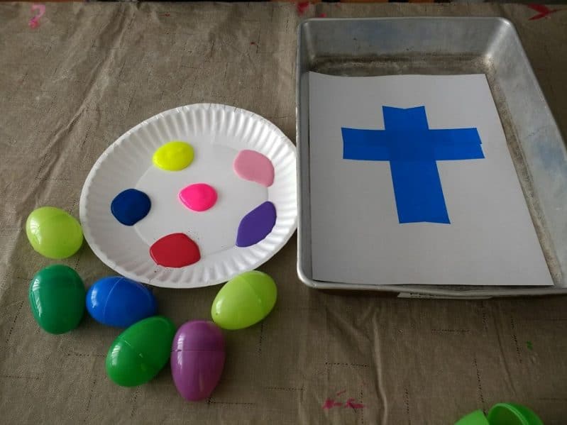 Try a fun Easter egg painting activity to make a tape resist cross with your kids!